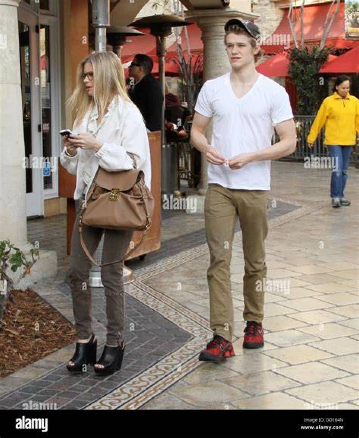Lucas Till and his girlfriend walk through The Grove West Hollywood