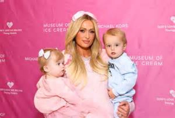 PHOTO Paris Hilton poses with a baby at handbag launch in